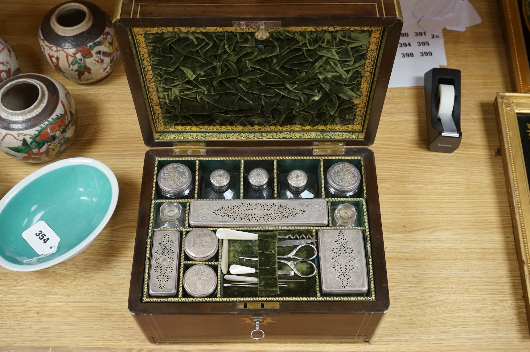 A mid 19th century mahogany brass bound and mounted toilet box, with tooled leather and velvet interior. Fitted inside with glass plated topped bottles and boxes. 31cm wide x 19cm high